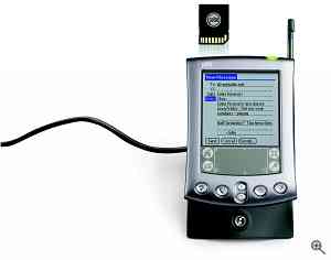 Palm's m505 PDA, shown in docking cradle. Courtesy of Palm - click for a bigger picture!