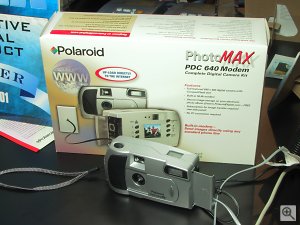 Polaroid's PDC640M digital camera shown with retail packaging behind it. Copyright (c) 2001, Michael R. Tomkins, all rights reserved. Click for a bigger picture!